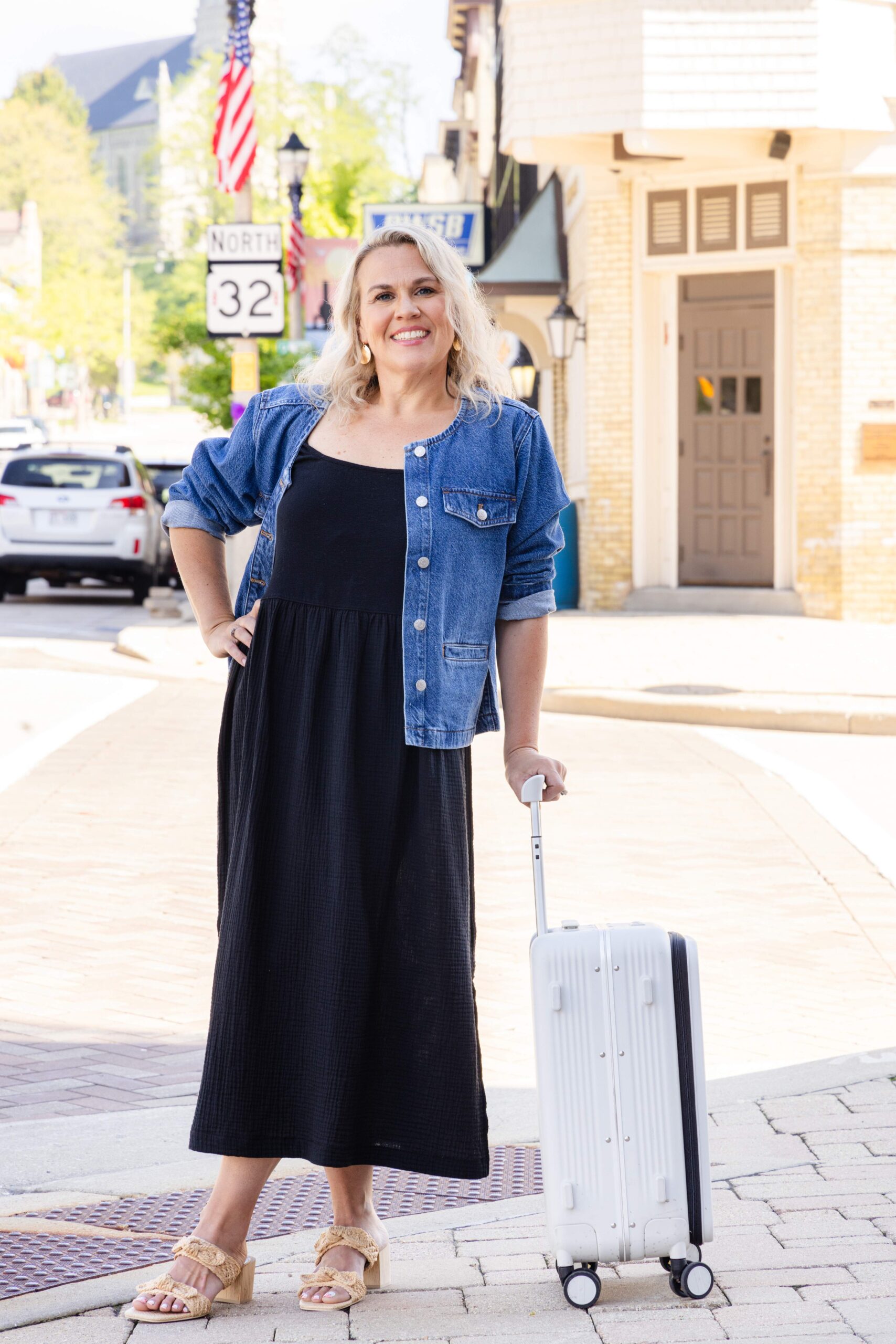 Stephanie Steinert standing with white suitcase