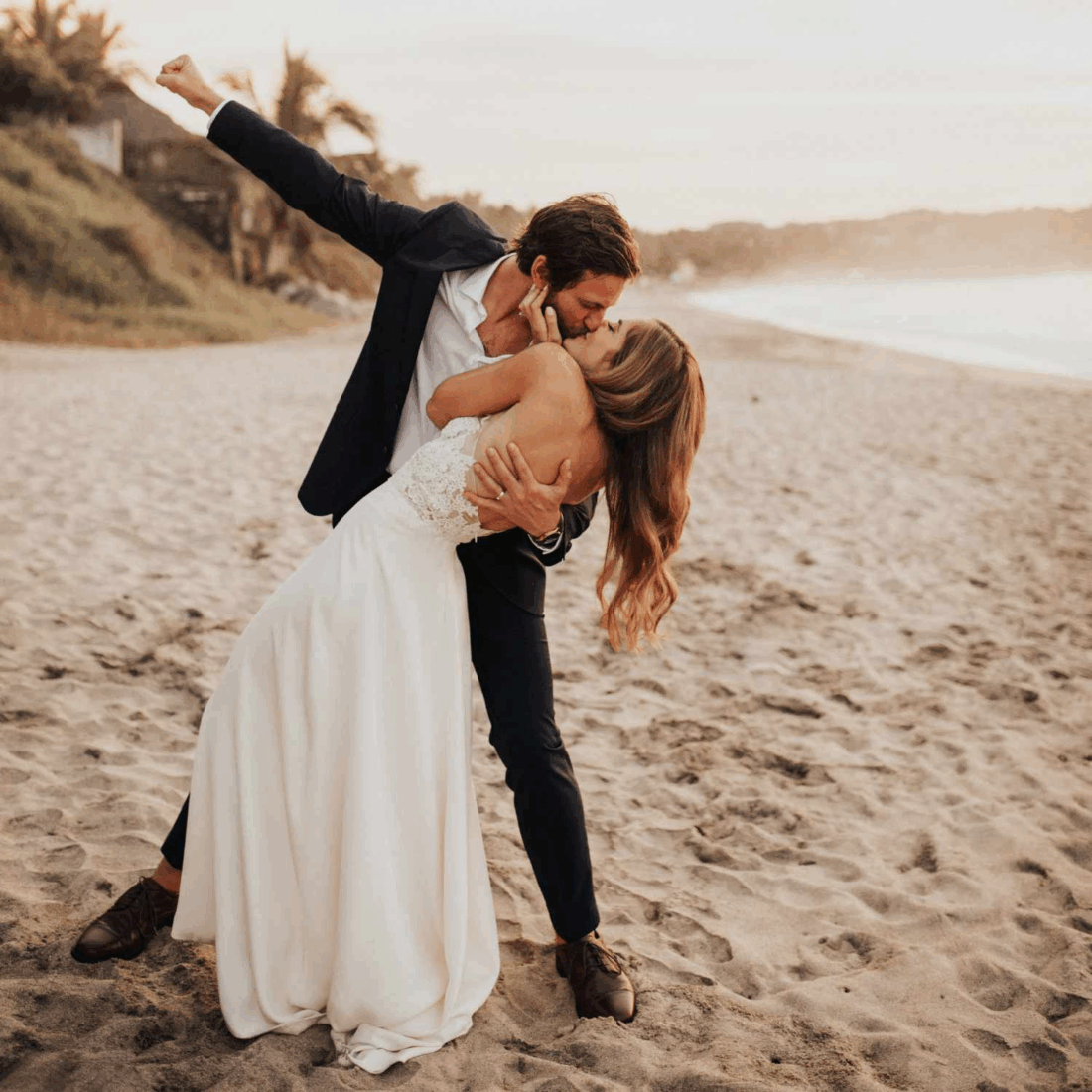 Couple sharing a romantic kiss on the beach.