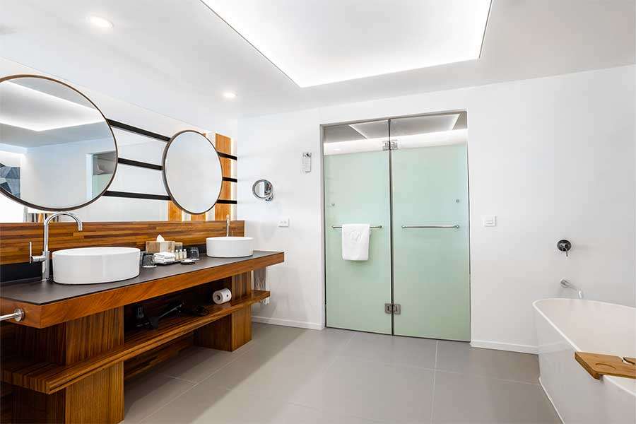 Modern bathroom with wooden accents and mirrors