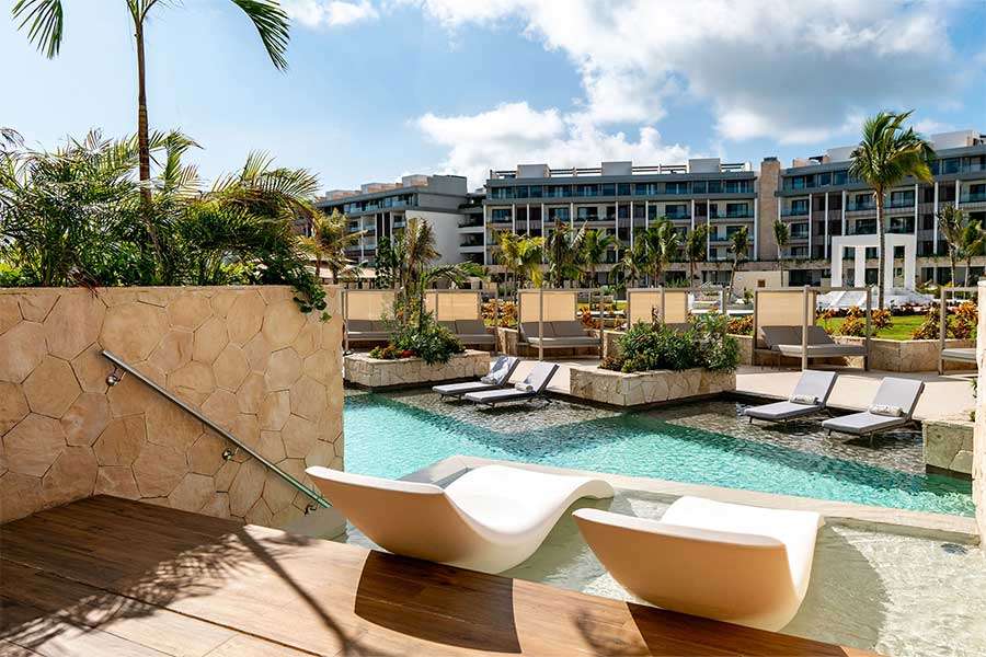 Luxury poolside lounge area with modern architecture.