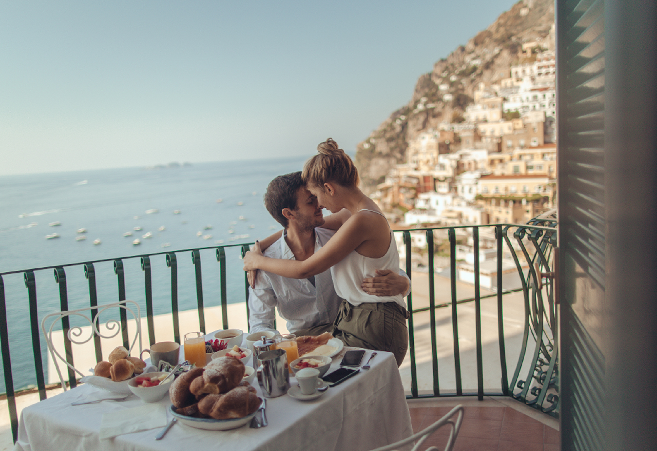 Couple enjoying breakfast on a scenic balcony