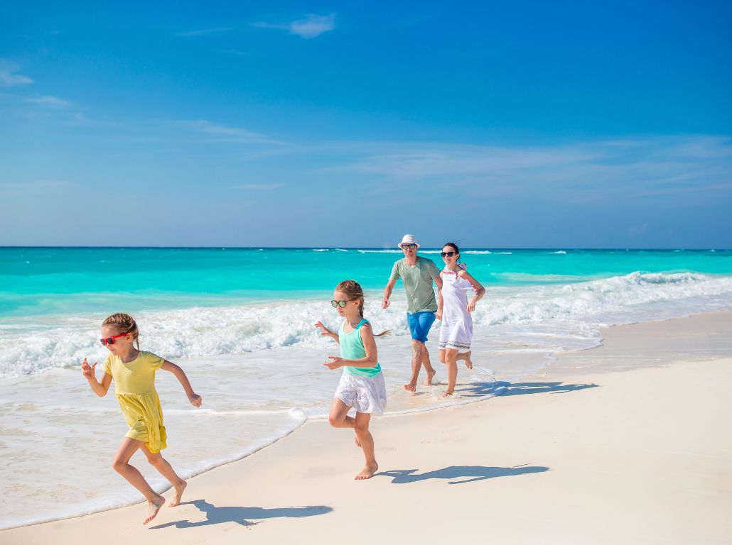 Family enjoying a sunny day on the beach.
