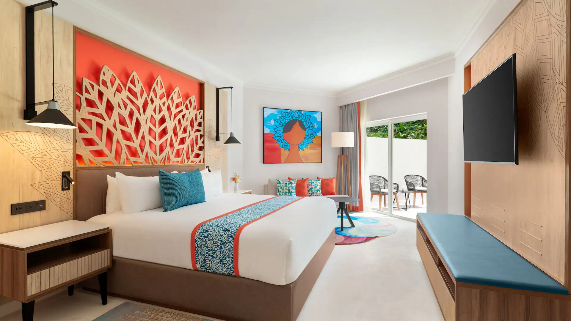 Modern hotel room with colorful decor and artwork.