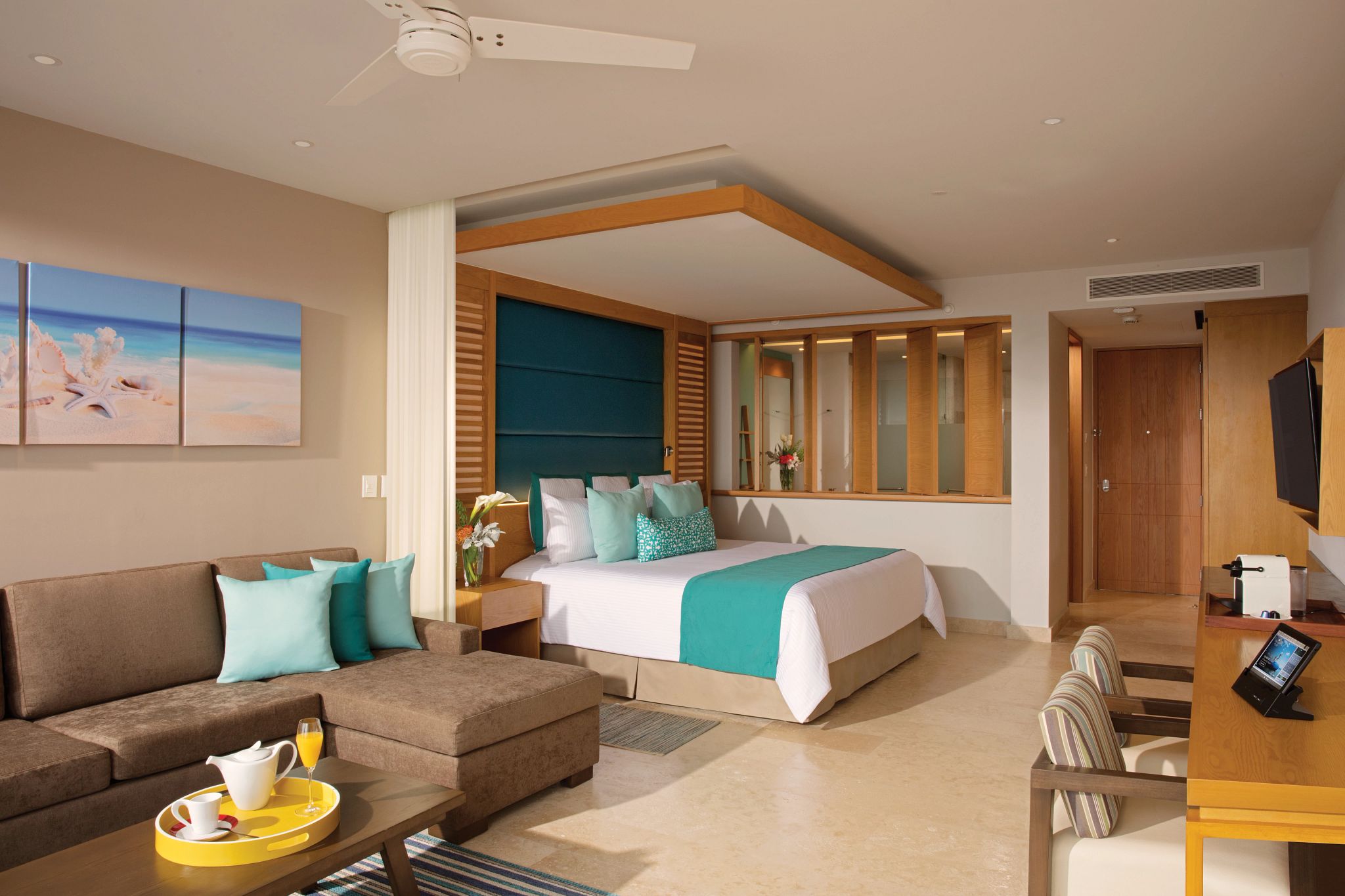 Luxurious hotel room with king-size bed and sofa.
