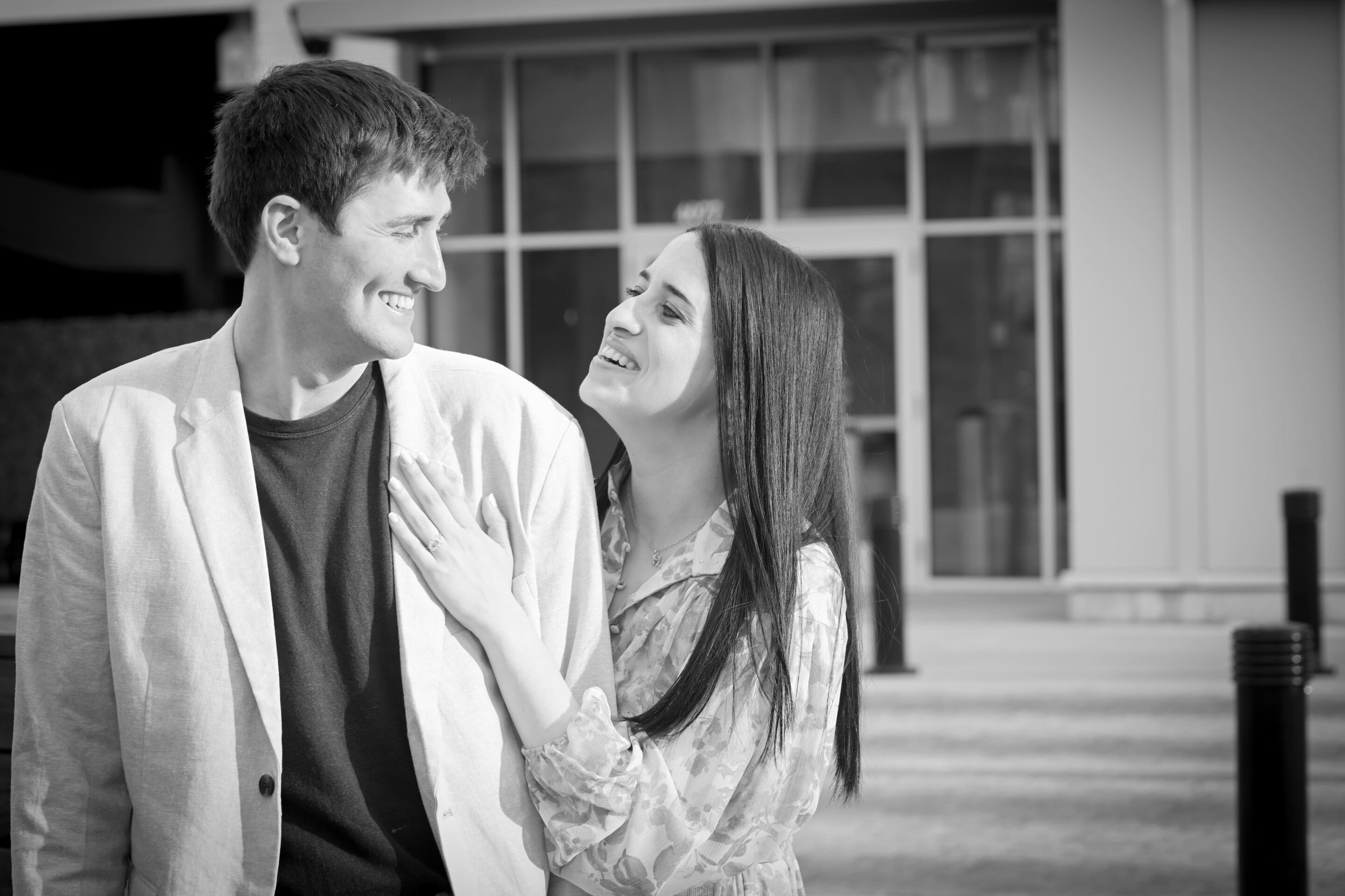 Smiling couple looking at each other outdoors.