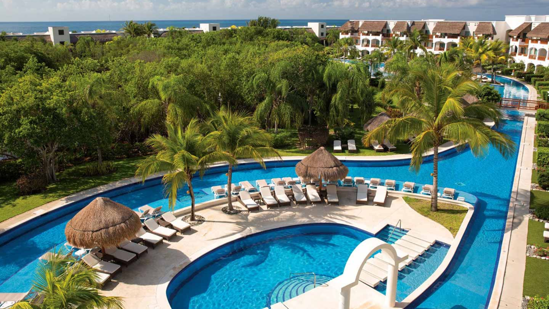3 Resort pool with palm trees and lounge chairs.