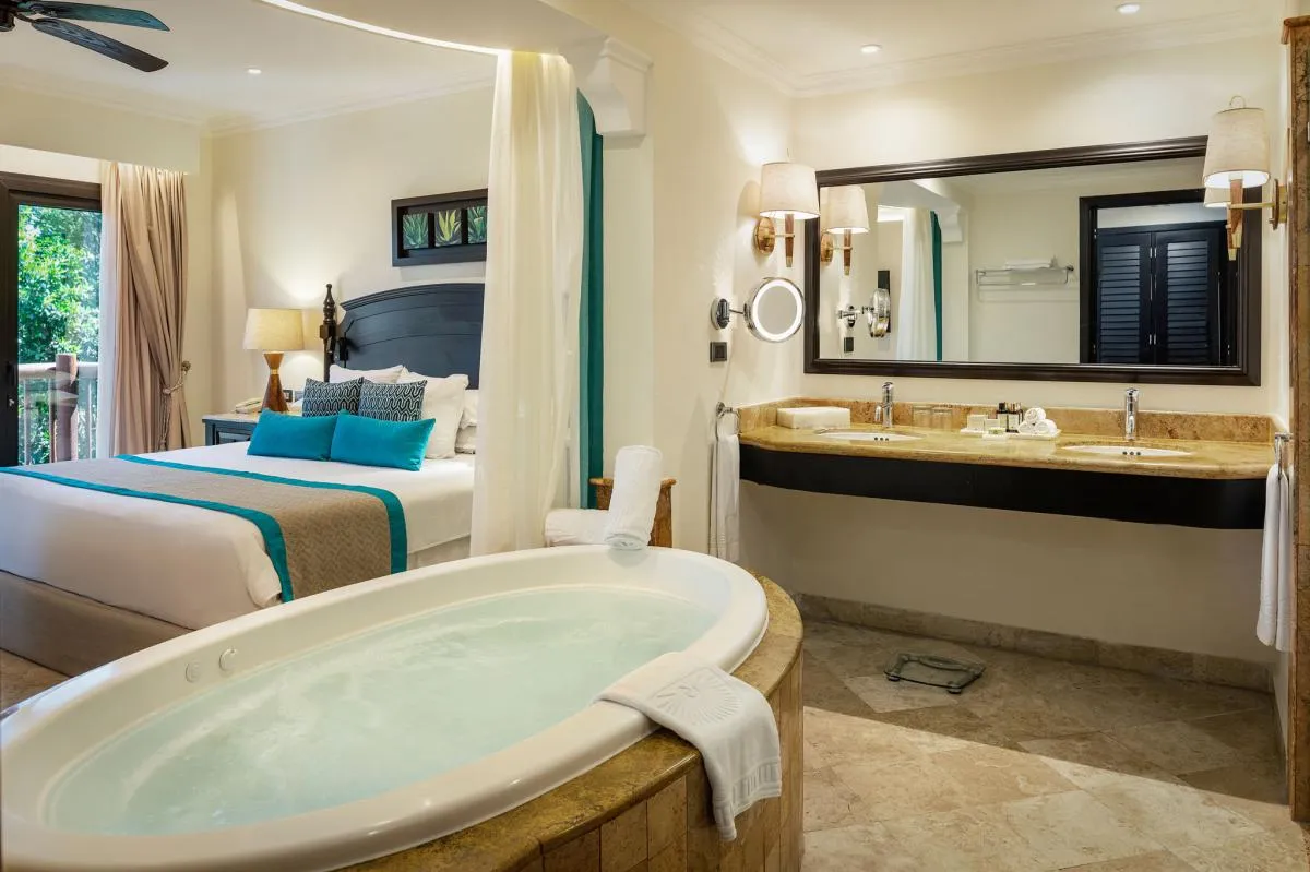 Luxury hotel suite with jacuzzi and king bed.