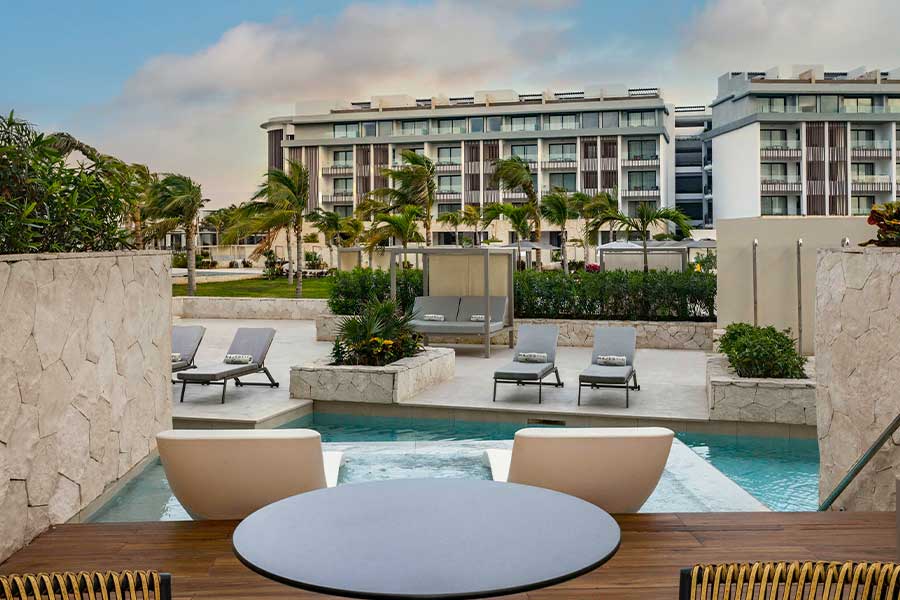 Luxury resort pool with modern apartments view.