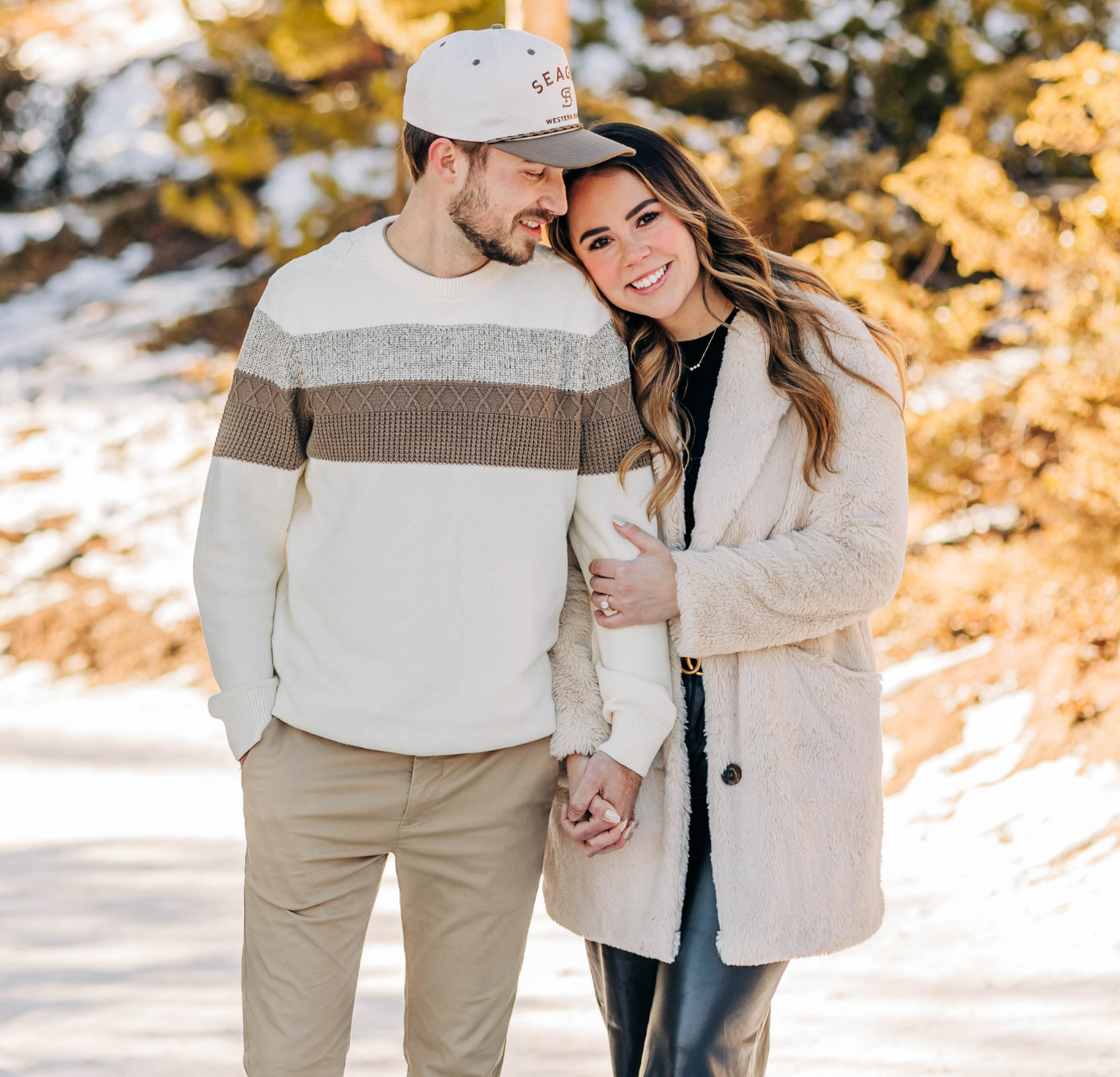 Couple smiling in snowy winter setting
