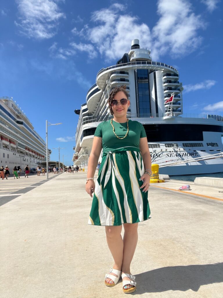 WhatsApp Image 2026-06-11 at 05.01.20 (1) Woman standing in front of large cruise ship.