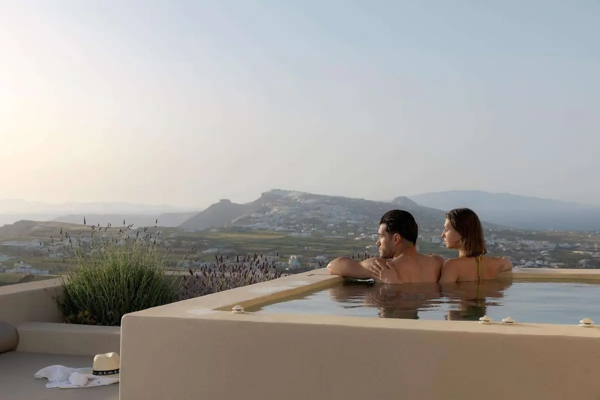 Guests relaxing in the suite hot tub at dusk