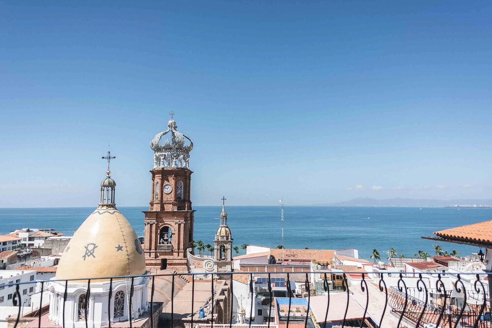 The view from La Capella across the rooftops and church towers of El Centro, Puerto Vallarta, to the bay