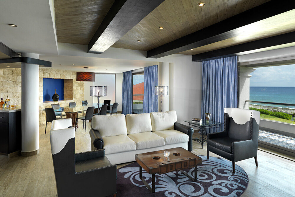 Rock Suite living area with sofas and floor to ceiling ocean windows, Heaven side