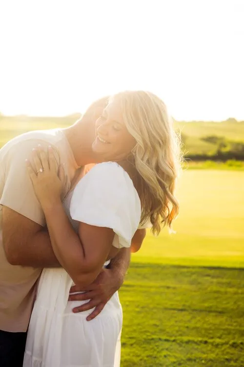 Kassidy and Nelius embracing in the evening sun