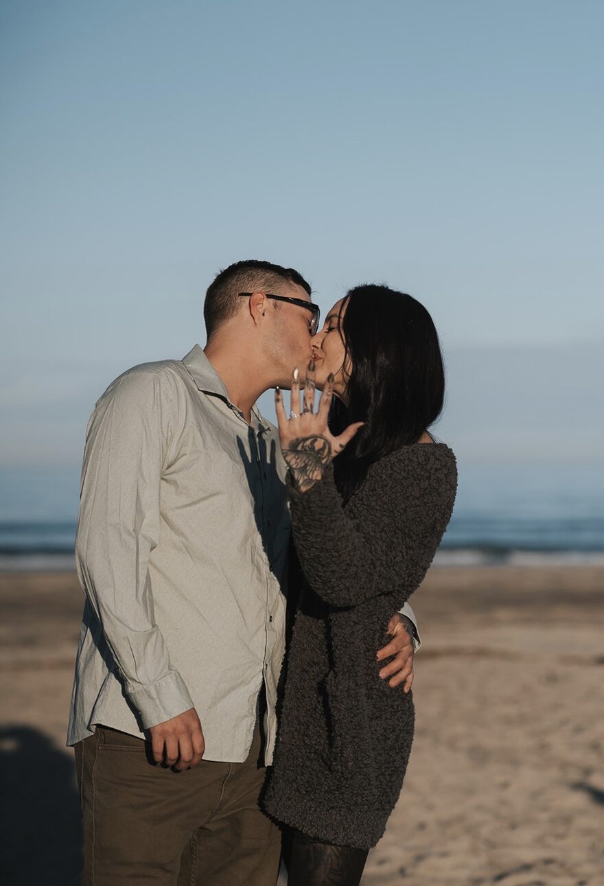 Sonya and Tyler kissing on the beach